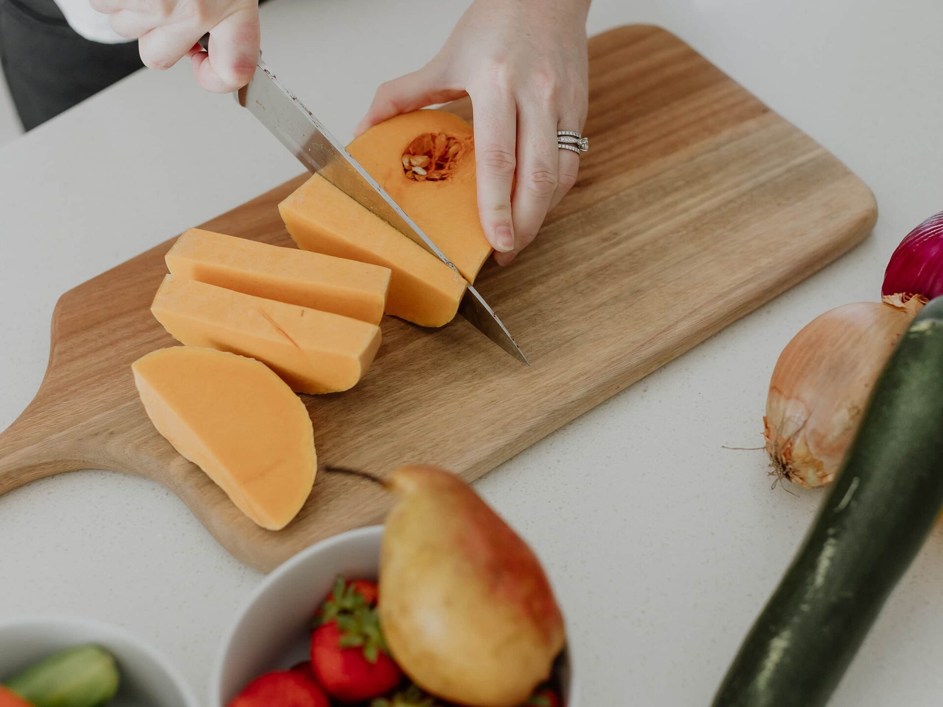 Kendall cutting up fruit and vegtables in the kitchen