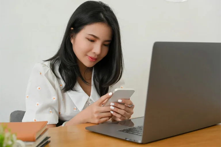 Woman Chatting with Someone on Her Smartphone