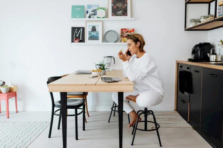 Woman Talking to Someone While Sitting In Front of a Laptop Computer_web